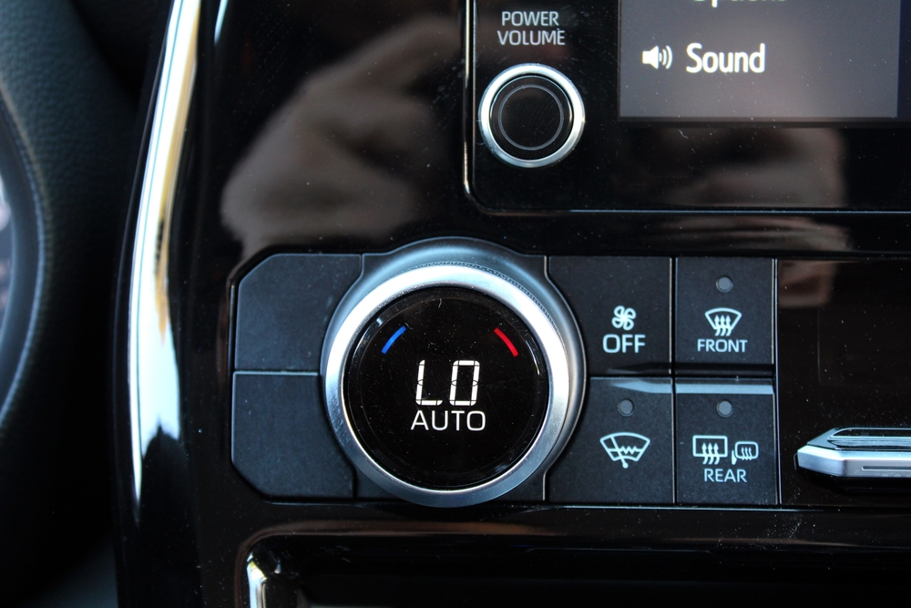 Maximum cooling from car. Low temperature on car dashboard display. Cooling your car on a hot day. Hot summer outside. Car Climate Control. 